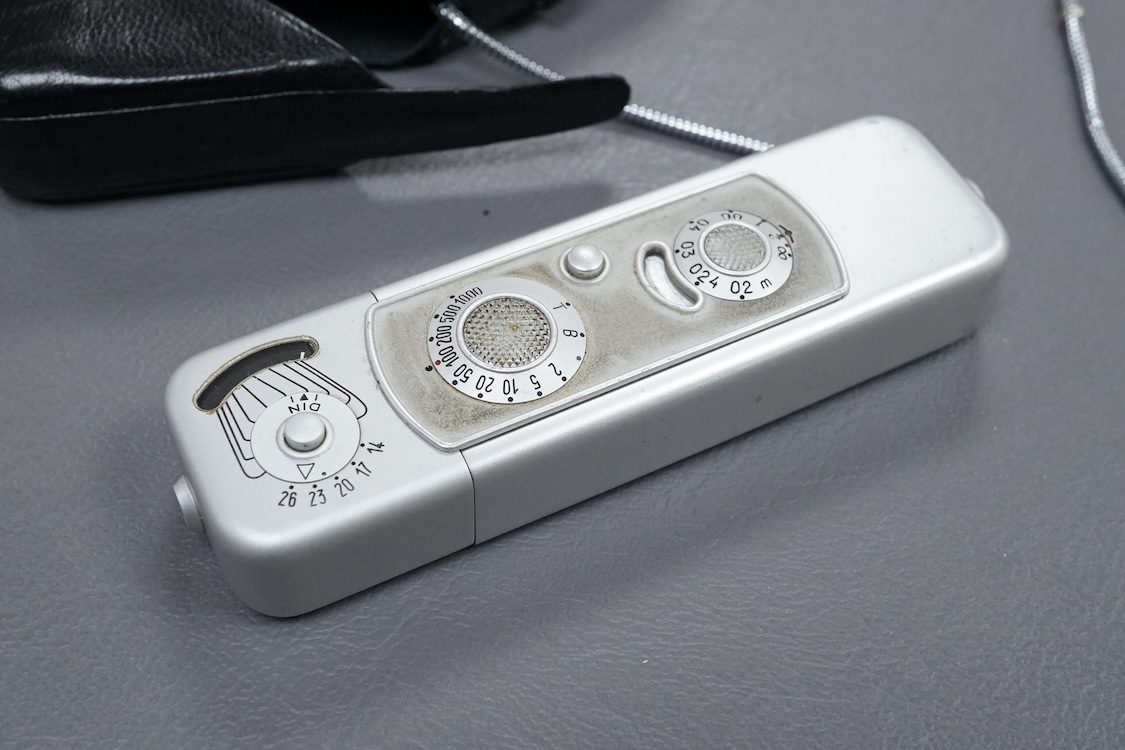 A Minolta Minox miniature camera Model B, in its original leather case with metal lanyard.